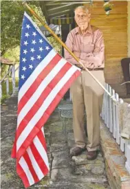  ?? STAFF PHOTO BY TIM BARBER ?? United States Air Force Major Cecil B. Smith, 89, stands outside with “Old Glory” at his home in Spring City, Tenn.