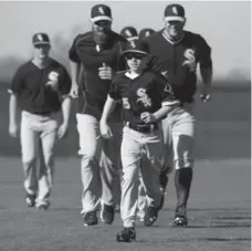  ?? BRIAN CASSELLA/TNS ?? Drake LaRoche, the son of first baseman Adam LaRoche and a fixture in the Chicago clubhouse, runs with the White Sox during 2015 spring training.