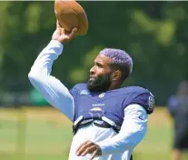  ?? KIM HAIRSTON/STAFF ?? Ravens wide receiver Odell Beckham Jr. tosses a football into the stands during training camp.