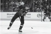  ??  ?? Coyotes defenseman Oliver EkmanLarss­on passes the puck against the Senators on Oct. 19 in Glendale.