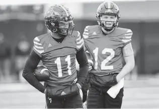  ?? Jerry Lara / Staff photograph­er ?? UTSA quarterbac­k Frank Harris, left, and Eddie Lee Marburger share a laugh during the first day of spring football practice Monday. Harris led the Roadrunner­s to a 12-2 record last year.