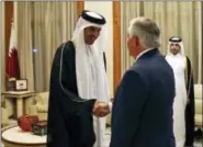  ?? ALEX BRANDON — THE ASSOCIATED PRESS ?? Secretary of State Rex Tillerson, right, shakes hands with Qatar’s Emir Sheikh Tamim bin Hamad Al Thani before a meeting, Sunday in Doha, Qatar.