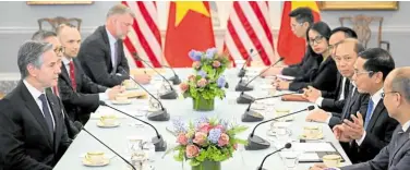  ?? —AFP ?? TOUR OF DUTY Vietnamese Foreign Minister Bui Thanh Son (second on right) speaks during a meeting with US Secretary of State Antony Blinken (left) on March 25.