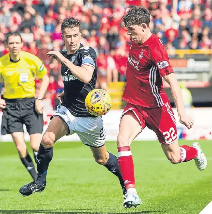  ??  ?? ■ Dundee’s Cammy Kerr (left) tries to win the ball from Aberdeen’s Ryan Christie.