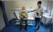  ?? ASSOCIATED PRESS FILE PHOTO ?? Long COVID patient Gary Miller, left, receives treatment from physiother­apist Joan Del Arco at the Long COVID Clinic at King George Hospital in Ilford, London, in 2021.