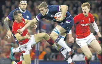  ??  ?? Gareth Davies halts Scotland’s Jonny Gray in Cardiff yesterday