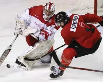  ?? PETER POWER/THE CANADIAN PRESS ?? Senators prospect Alex Formenton, who scored the eventual winner, loses a foot race with Denmark goalie Emil Gransoe in Friday’s exhibition action in St. Catharines. The Canadians won 5-2, hours before final cuts were made.