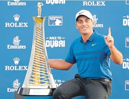  ?? AP. ?? Open champion and Ryder Cup hero Francesco Molinari poses with the Race to Dubai trophy.