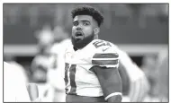  ?? File Photo/AP ?? Cowboys running back Ezekiel Elliott stands on the field during warmups Oct. 1 before a game against the Rams in Arlington, Texas.