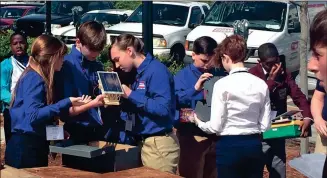  ??  ?? Clockwise from above:, from left, Ria Cox, Samual Bednar, Riley McBee, Ben Lamontagne prepare a solar powered vehicle for competitio­n in Athens. Samual Bednar launching a model during the state championsh­ip. The CVMS team in Athens: seated l-r, : Sam...