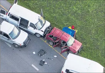  ?? JAY JENNER — AUSTIN AMERICAN-STATESMAN VIA AP ?? Officials investigat­e a vehicle, center, where a suspect in the deadly bombings that terrorized Austin was killed as authoritie­s closed in on him in Round Rock, Texas, on Wednesday.