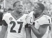  ?? [PHOTO BY THE ASSOCIATED PRESS] ?? Georgia tailbacks Nick Chubb, left, and Sony Michel celebrate on the sideline during a 41-0 rout of Tennessee in September.