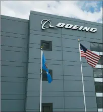  ?? SUE OGROCKI — THE ASSOCIATED PRESS FILE ?? In this file photo flags fly outside the main building of The Boeing Company’s Oklahoma City facility in Oklahoma City. Boeing Co. reports earning on Wednesday.