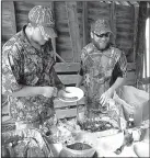  ?? Arkansas Democrat-Gazette/BRYAN HENDRICKS ?? Dove hunters refuel after a hot morning with barbecue and cornbread.