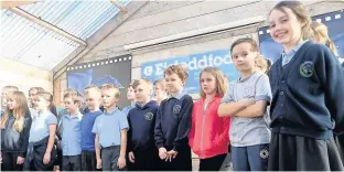  ??  ?? Pupils from Ysgol Gymuned Bryngwran sang at the opening of the new community hub in Bryngwran