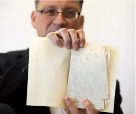  ??  ?? National Library archival expert and humanities collection curator Stefan Litt reveals manuscript­s by novelist Franz Kafka at the National Library of Israel in Jerusalem. — AFP