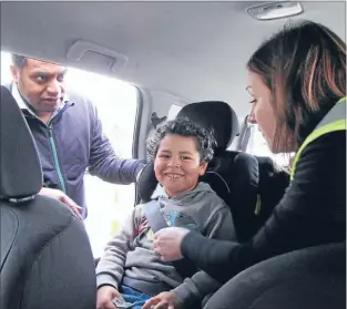  ??  ?? Click goes the seatbelt: From left, Kris Faafoi, his son George, 5, and Jo Boxall from Baby on the Move Wellington North discuss the strap height of George’s car seat.