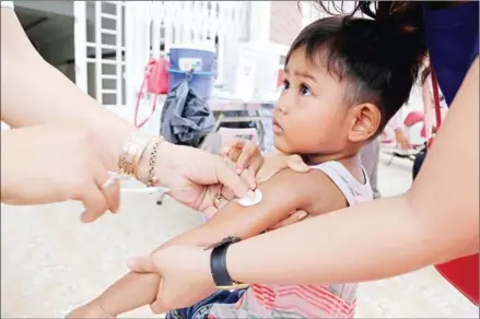  ?? HENG CHIVOAN ?? A young boy receives an anti-malaria vaccinatio­n in Kakab commune’s Chomkar Ouv Loek village, in the capital’s Por Sen Chey district, on Wednesday.