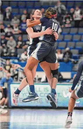  ?? Jessica Hill/Associated Press ?? Villanova’s Brianna Herlihy and Christina Dalce (10) embrace in the air as they celebrate their team’s win against UConn last season in Hartford.