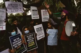  ?? Altaf Qadri / Associated Press ?? A Sikh student in New Delhi joins a protest against banning Muslim girls from wearing a hijab to enter a public school in the Indian state of Karnataka.