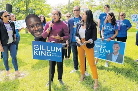  ?? RICARDO RAMIREZ BUXEDA/ORLANDO SENTINEL ?? Left to right, Stephanie Murphy, Carlos Guillermo Smith and Anna Eskamani watch Sofia Garduno, 19, a UCF student and a Dreamer, speak to the crowd at an early voting rally hosted by the Democrats Monday at the University of Central Florida.