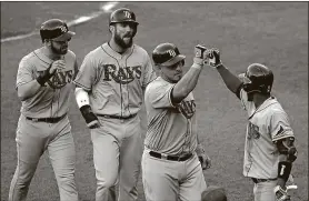  ?? PRESS PATRICK SEMANSKY / THE ASSOCIATED ?? The Rays’ Wilson Ramos, second from right, fist-bumps teammate Adeiny Hechavarri­a after batting in Evan Longoria, left, and Steven Souza Jr., second from left, on a home run in the fifth inning Saturday against the Orioles in Baltimore.