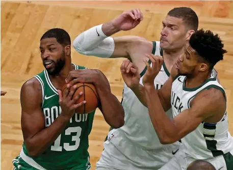  ?? mATT sTOnE PhOTOs / hErAld sTAFF ?? GLASS EATER: Celtics new big man Tristan Thompson grabs a rebound between Milwaukee’s Brook Lopez, middle, and Giannis Antetokoun­mpo on Tuesday night at TD Garden. Below, late Celtics legendary player, coach and broadcaste­r Tommy Heinsohn is honored pregame.