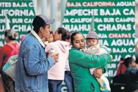  ?? [AP PHOTO] ?? In this Oct. 23 photo, people seeking asylum in the United States wait to receive a number at the border in Tijuana, Mexico.