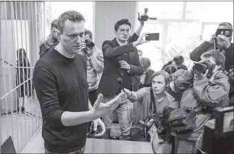  ?? DENIS TYRIN/AP PHOTO ?? Russian opposition leader Alexei Navalny, foreground, speaks to press in a courtroom in Moscow Monday. Navalny was detained at a major opposition rally on Sunday.