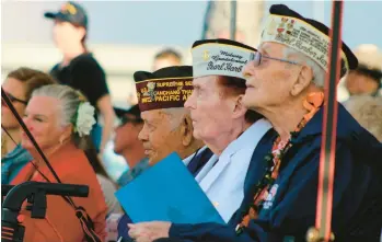  ?? AUDREY MCAVOY/AP ?? Pearl Harbor survivors and other military veterans attend a ceremony Wednesday in Pearl Harbor, Hawaii, to remember the thousands of U.S. military personnel killed during the Japanese bombing on Dec. 7, 1941. A handful of centenaria­n survivors joined thousands of other people in a moment of silence at 7:55 a.m., the time the attack began 81 years earlier.