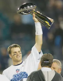  ?? FILE ?? Tom Brady holds the Super Bowl trophy after the Patriots beat the Eagles in Super Bowl XXXIX.