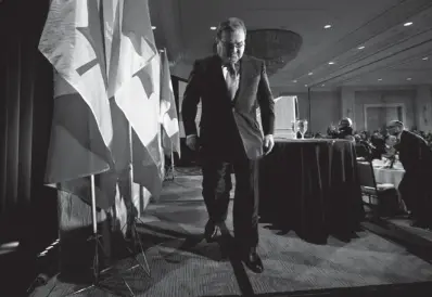  ?? DARRYL DYCK / THE CANADIAN PRESS ?? Federal Finance Minister Jim Flaherty leaves the podium after delivering a post-budget speech to the Vancouver
Board of Trade on Friday. Flaherty intends on sticking around until the budget is balanced in 2015.