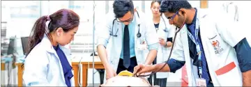  ??  ?? Students practise on an anatomical model in a simulation at Melaka-Manipal Medical College.