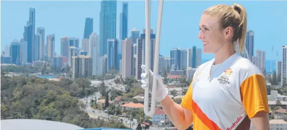  ?? Picture: GLENN HAMPSON ?? Commonweal­th Games ambassador and athlete Sally Pearson with the Queens Baton looking over the Gold Coast.