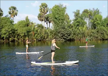  ?? POST STAFF ?? Foreign tourists paddle along a creek in Kampot province on a stand-up paddleboar­d in 2015.