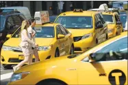  ?? Timothy A. Clary / Getty Images ?? A new $2.50 surcharge has taken effect for New York City cabs.