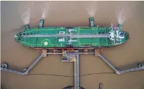  ?? Reuters ?? Crude is unloaded at a terminal in Zhejiang province