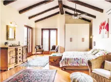  ??  ?? The master suite inside of Deane’s home in Italy features high ceilings.