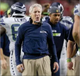  ?? ROSS D. FRANKLIN — THE ASSOCIATED PRESS ?? Seattle coach Pete Carroll cheers a touchdown against the Arizona Cardinals during a playoff game in January. The Seahawks and Carroll have agreed on a contract extension keeping the oldest head coaching in the NFL locked up beyond the 2016 season.