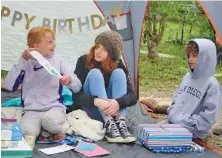  ?? PHOTO BY KAREN NAZOR HILL ?? While the grandparen­ts practiced 6 feet of social distancing from grandchild­ren Evie, Tilleigh and William, from left, the family celebrated Evie’s 10th birthday recently.