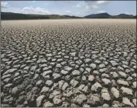  ?? (AP/Fernando Vergara) ?? The lakebed of Suesca lagoon sits dry and cracked Feb. 17 in Suesca, Colombia, after years of very little rainfall. A United Nations report released last week says humans are making Earth a broken and increasing­ly unlivable planet through climate change, biodiversi­ty loss and pollution. So the world must make dramatic changes to society, economics and daily life.