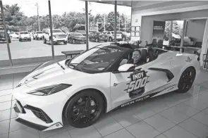  ??  ?? Shank sits in the 2021 Indy 500 Corvette Pace Car in the showcase room at Coughlin GM. Shank and wife Marybeth visited Coughlin Chevrolet to pick up one more of the spoils of victory, the white-and-black 2021 Corvette Stingray, one of four such pace cars created for this year’s recently completed Indy 500 that the Meyer Shank team won with now four-time Indy winner Hélio Castroneve­s at the wheel.