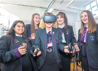  ?? Pictures: Steve MacDougall. ?? St John’s pupils at the exhibition. Sophie Bruce is wearing VR tech equipment watched by, from left, Ruhanni Salins, Caitlin Murray, Caragh Mcaninch and Dana Liddell.