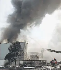  ?? — AFP photo ?? Firefighte­rs from Singapore Civil Defence Force (SCDF) extinguish a fire at a waste management plant in Singapore.