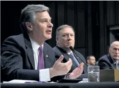  ?? CHIP SOMODEVILL­A/ GETTY IMAGES ?? FBI Director Christophe­r Wray and CIA Director Mike Pompeo testify before the Senate intelligen­ce committee that Russia is targetting the upcoming U. S. midterm elections.