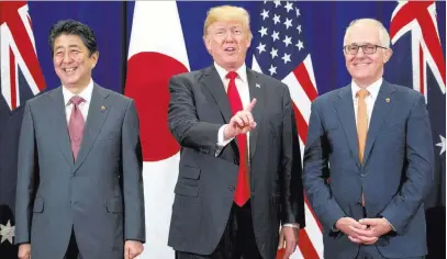  ?? Andrew Harnik ?? The Associated Press President Donald Trump, accompanie­d by Japanese Prime Minister Shinzo Abe, left, and Australian Prime Minister Malcolm Turnbull, speaks to reporters at a meeting Monday during the ASEAN Summit at the Sofitel Philippine Plaza in...