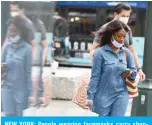  ??  ?? NEW YORK: People wearing facemasks carry shopping bags as they walk on a street near Herald Square in New York City. The United States saw only a small rise in inflation in September, government data released yesterday said, as consumer preference­s shifted amid the ongoing pandemic. —AFP