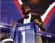  ?? John Locher / Associated Press ?? Oregon defensive end Kayvon Thibodeaux holds a jersey after being picked by the New York Giants with the fifth pick of the NFL draft Thursday.