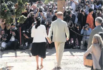 ??  ?? BRITAIN’S Prince Harry, the Duke of Sussex and his wife Meghan, Duchess of Sussex, walk hand in hand. The couple are turning their backs on their royal duties and want more independen­ce. | EPA-EFE