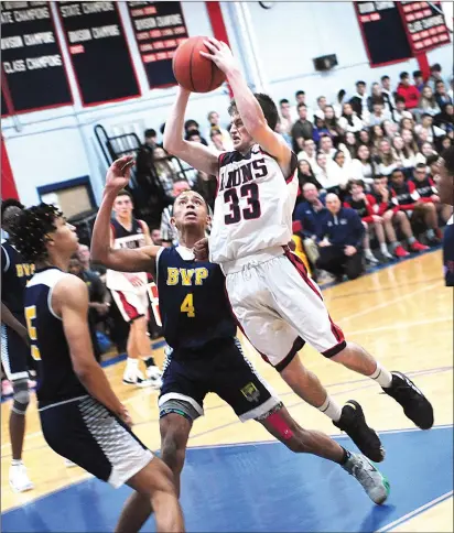  ??  ?? Lincoln senior point guard Josh Jahnz (33) attacks the hoop during the undefeated Lions 64-46 victory over Blackstone Valley Prep in a Division III clash Friday night at the Lions’ Den.
Kalil Fofana
(4) and